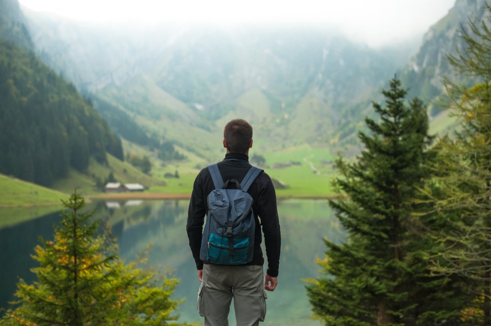 Traveler looking over a mountain lake